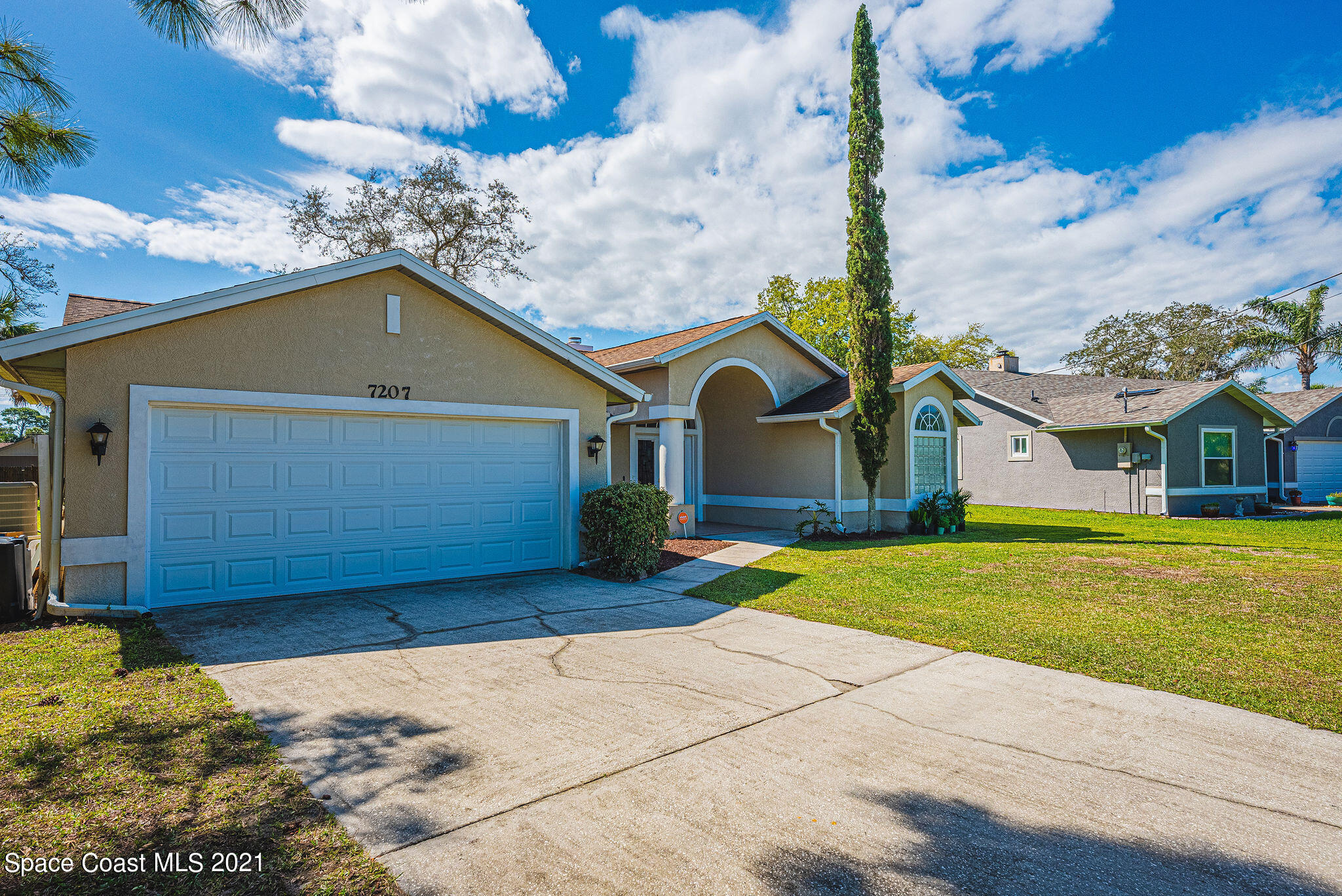 7207 Achilles Road Cocoa, FL 32927 - Photo 51 of 57 a front view of a house with a yard and garage