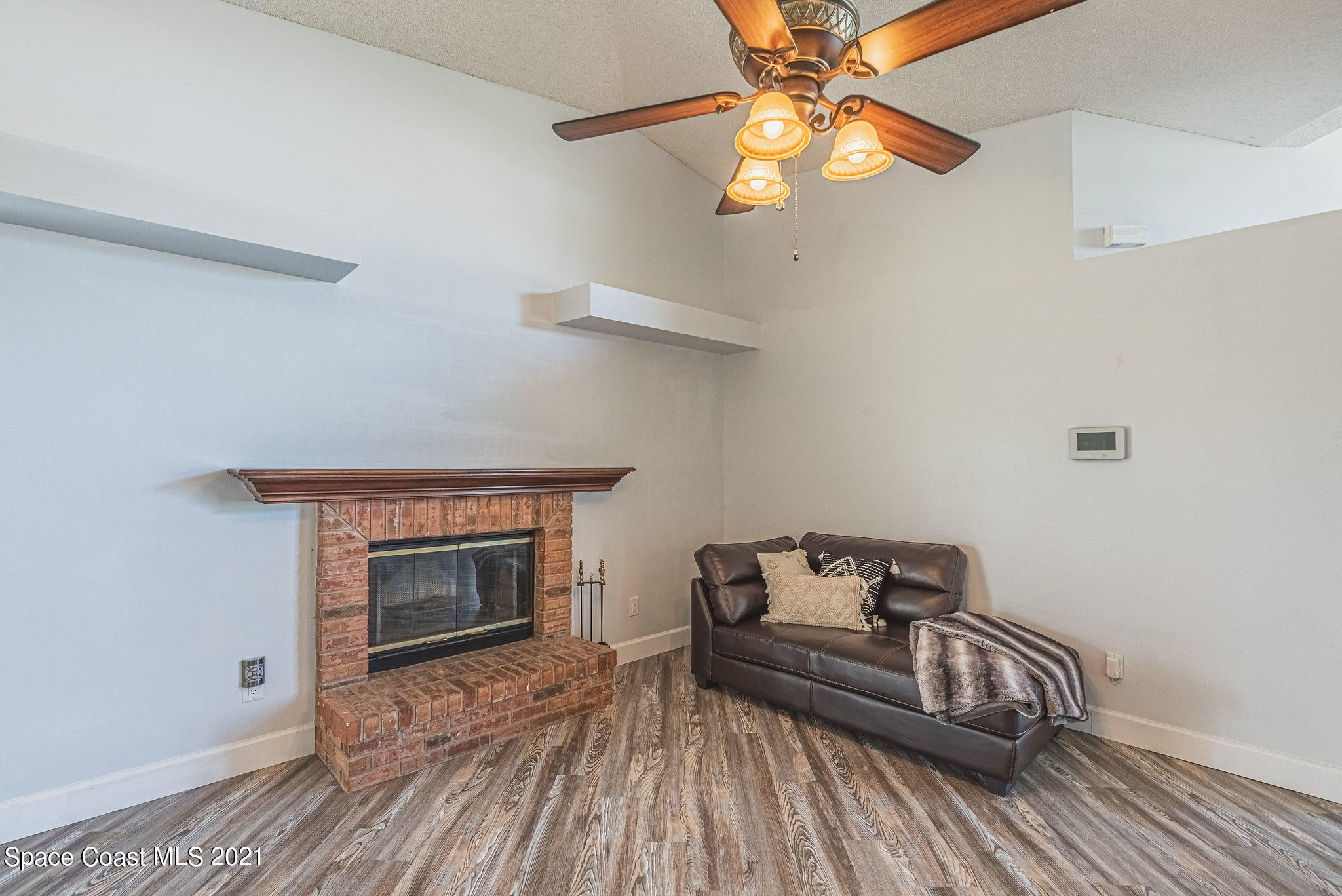 7207 Achilles Road Cocoa, FL 32927 - Photo 8 of 57 a bedroom with a bed and a fireplace