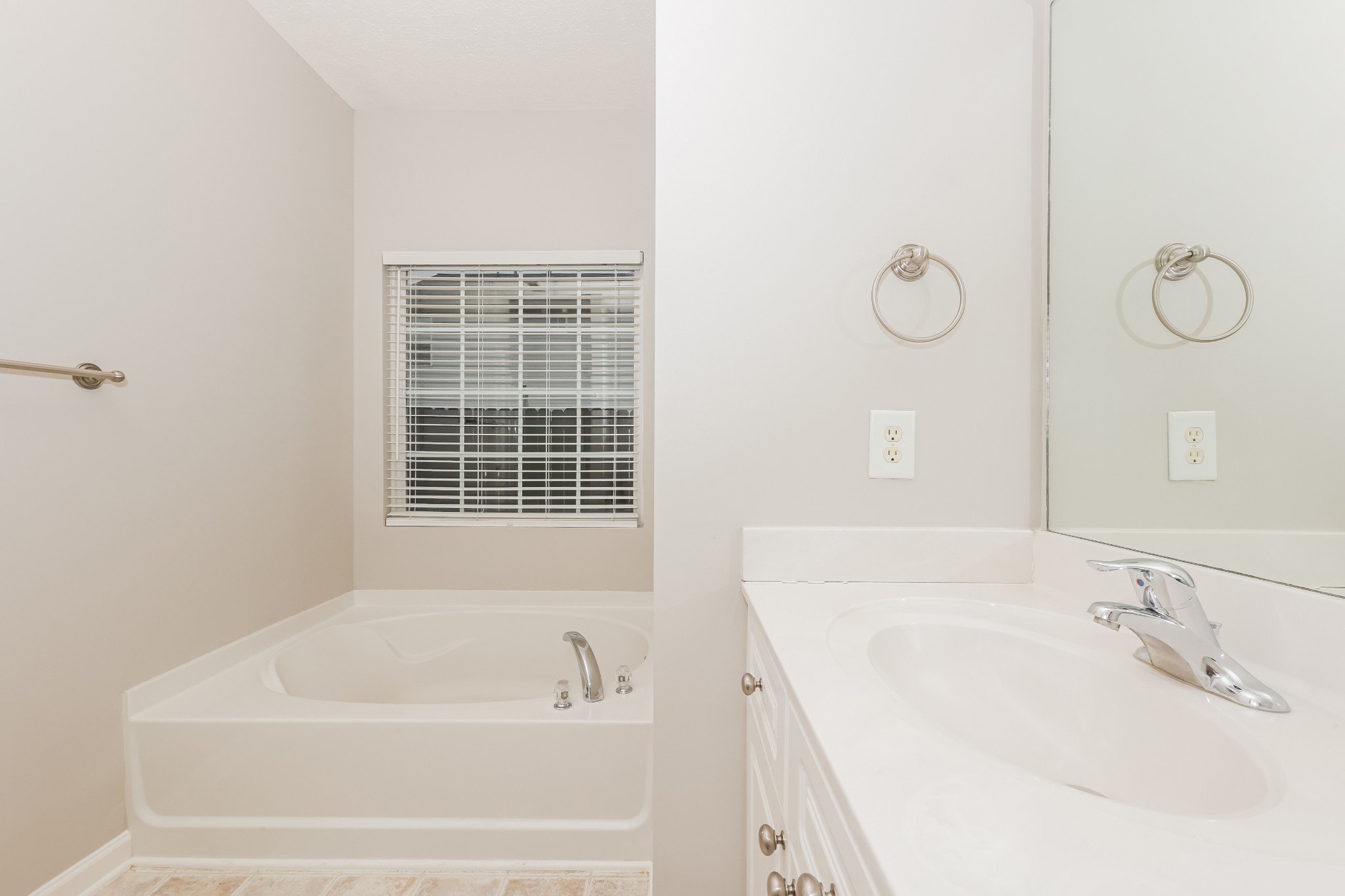 1006 Prince Street Spring Hill, TN 37174 - Photo 15 of 27 a bathroom with a tub a sink and a window
