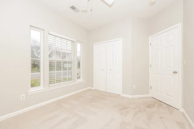 a bathroom with a granite countertop sink a toilet and shower