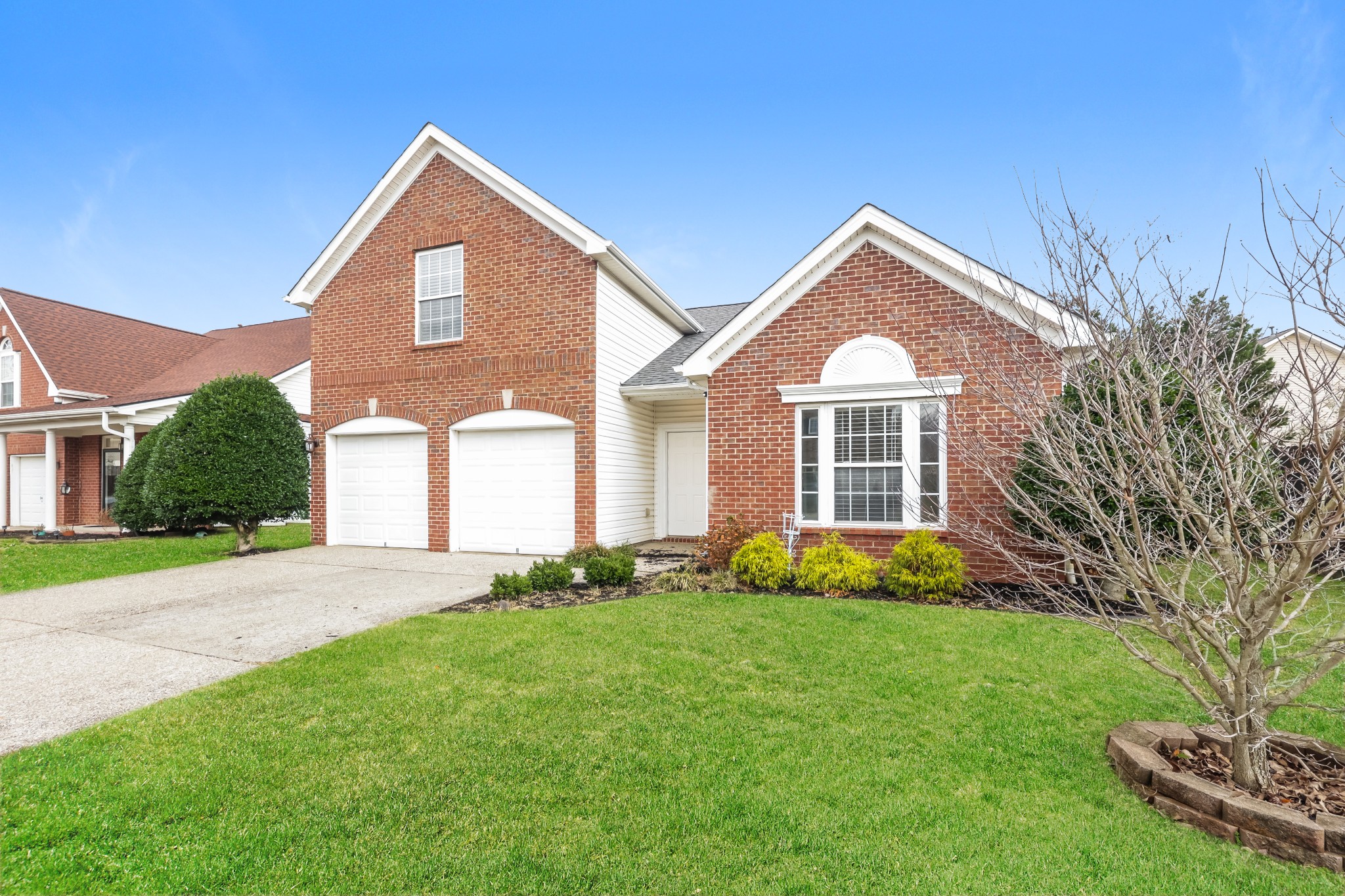 1006 Prince Street Spring Hill, TN 37174 - Photo 2 of 27 a front view of a house with a garden