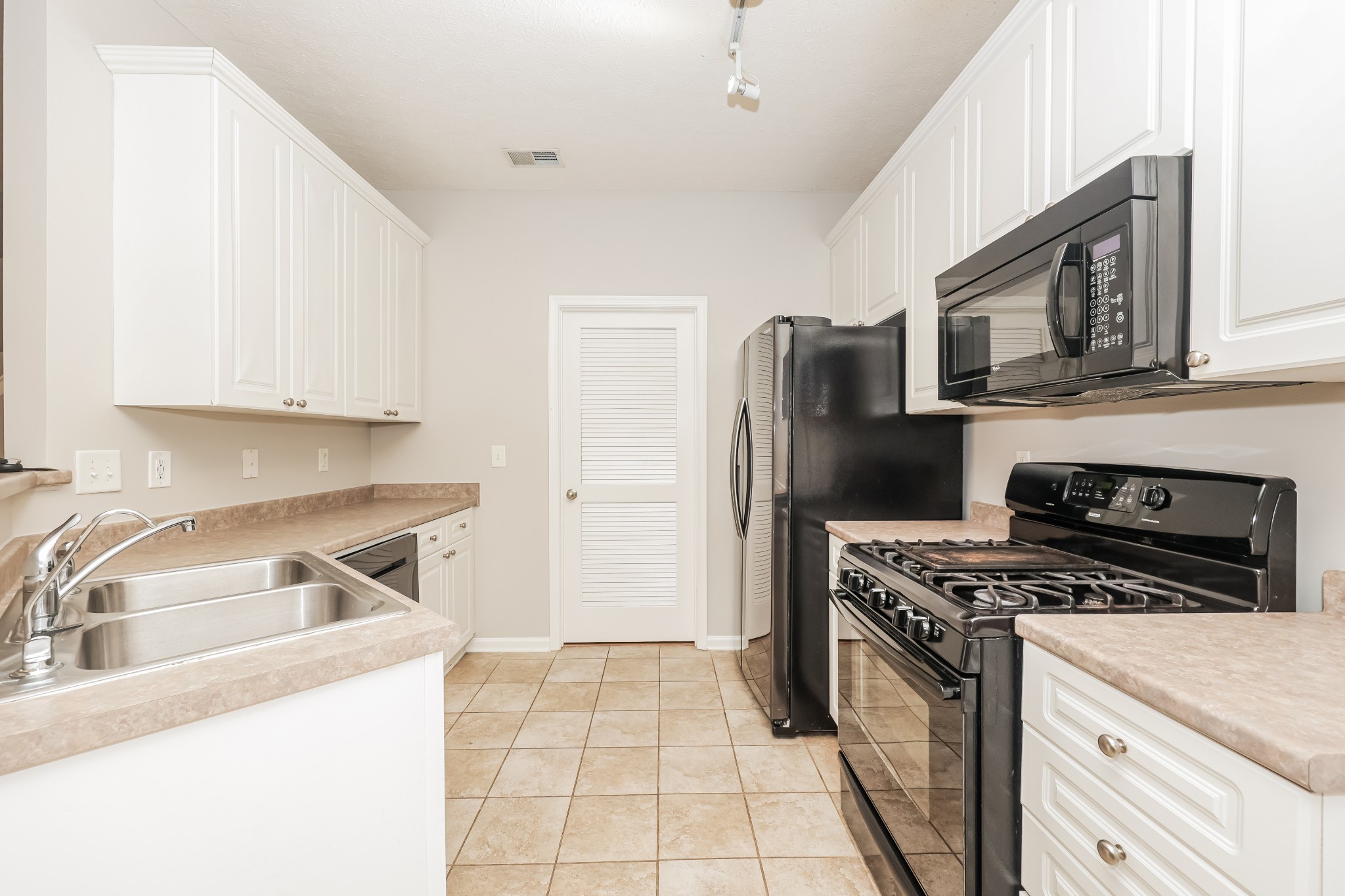 1006 Prince Street Spring Hill, TN 37174 - Photo 8 of 27 a kitchen with a stove a refrigerator and a sink