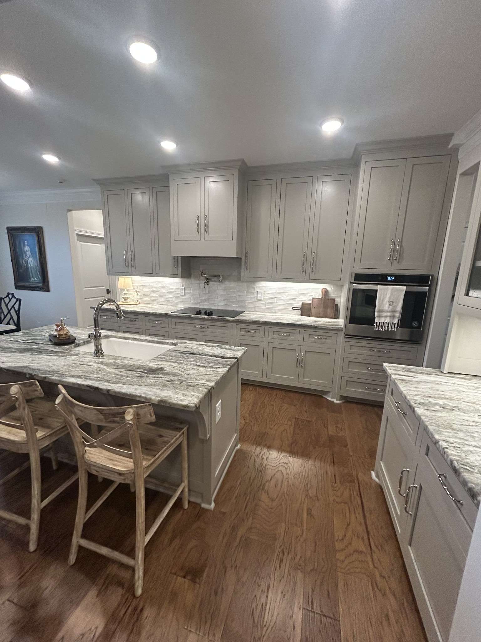 3755 McFall Road Palmyra, TN 37142 - Photo 12 of 18 a kitchen with kitchen island granite countertop wooden floors and stainless steel appliances