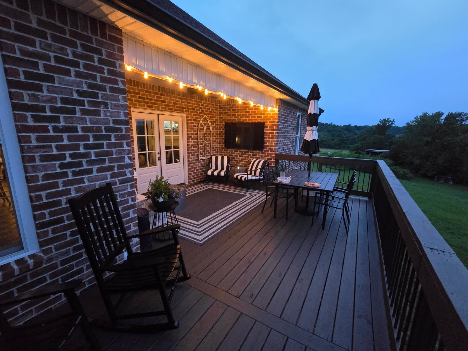 3755 McFall Road Palmyra, TN 37142 - Photo 3 of 18 a balcony with wooden floor table and chairs