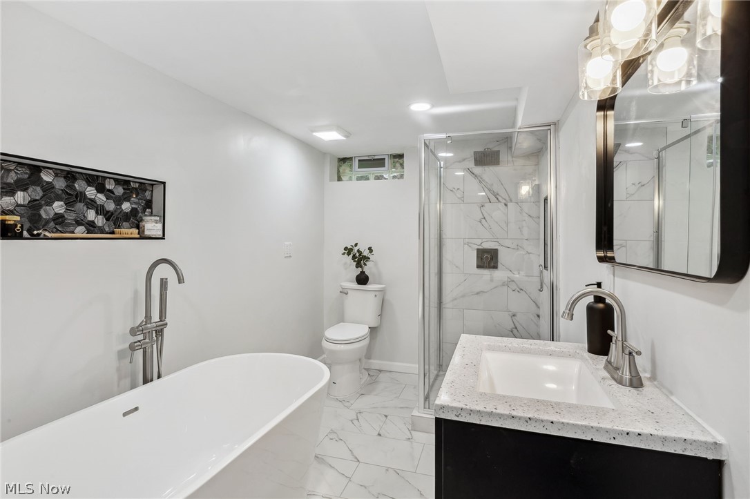 1407 Sunview Road Lyndhurst, OH 44124 - Photo 27 of 33 Full bathroom featuring vanity, tile patterned floors, separate shower and tub, and toilet