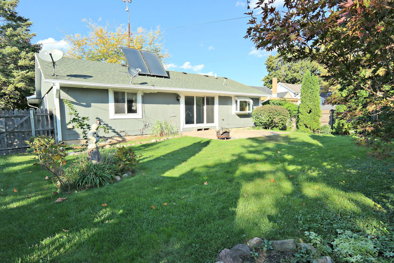 12005 Maple Avenue Hebron, IL 60034 - Photo 2 of 28 a front view of a house with a garden and yard