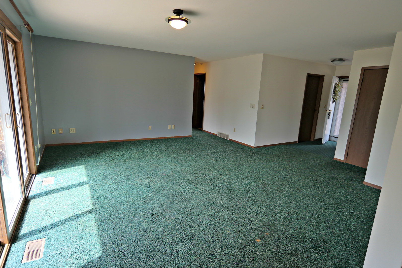 12005 Maple Avenue Hebron, IL 60034 - Photo 6 of 28 an empty room with a fireplace and a window
