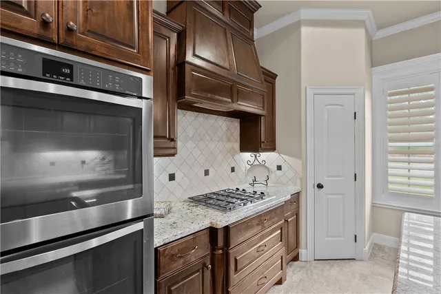 a kitchen with stainless steel appliances cabinets and stove