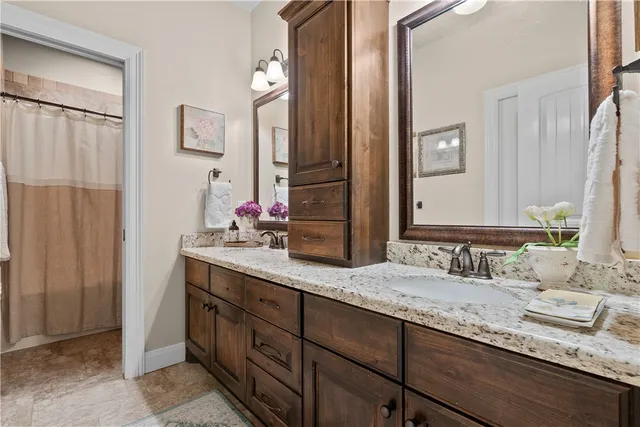a bathroom with a double vanity sink and a mirror