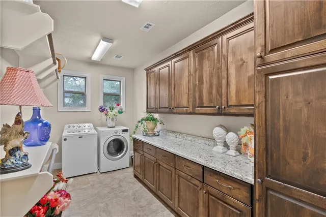 a utility room with sink dryer and washer