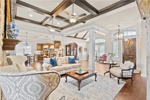 a living room with furniture and a chandelier