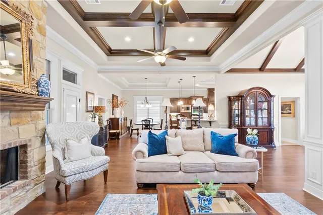 a living room with fireplace furniture and a large window