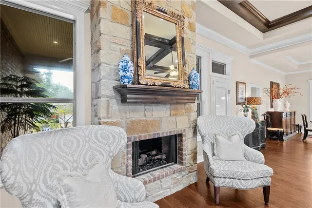 a living room with furniture a fireplace and a floor to ceiling window