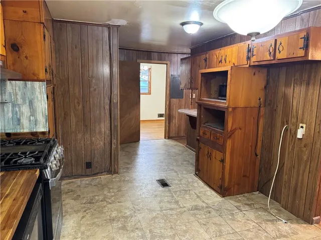 a kitchen with stainless steel appliances a stove a refrigerator and a stove