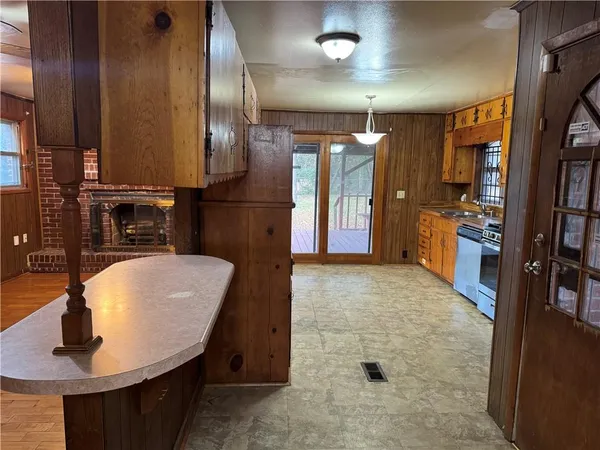 an empty room with a chandelier fan and closet