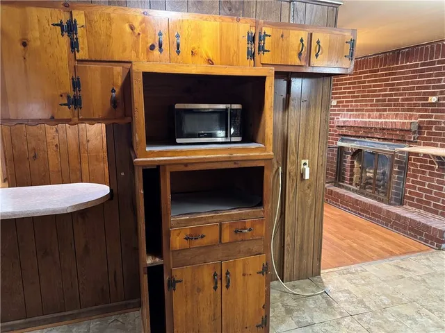 a kitchen with kitchen island granite countertop wooden cabinets a sink and a stove