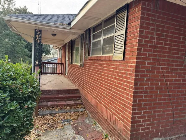 a view of a patio with table and chairs and wooden floor