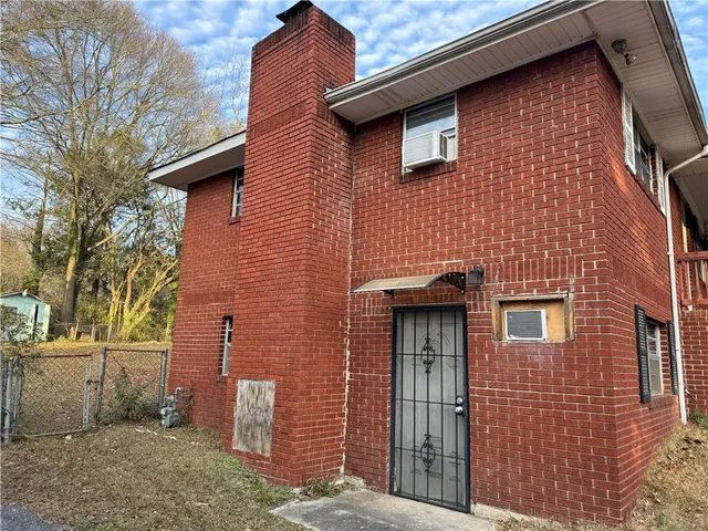 a brick building with a small yard