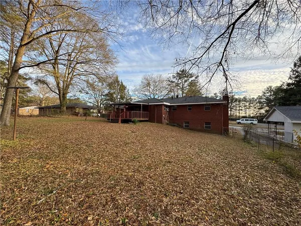 a backyard of a house with large trees