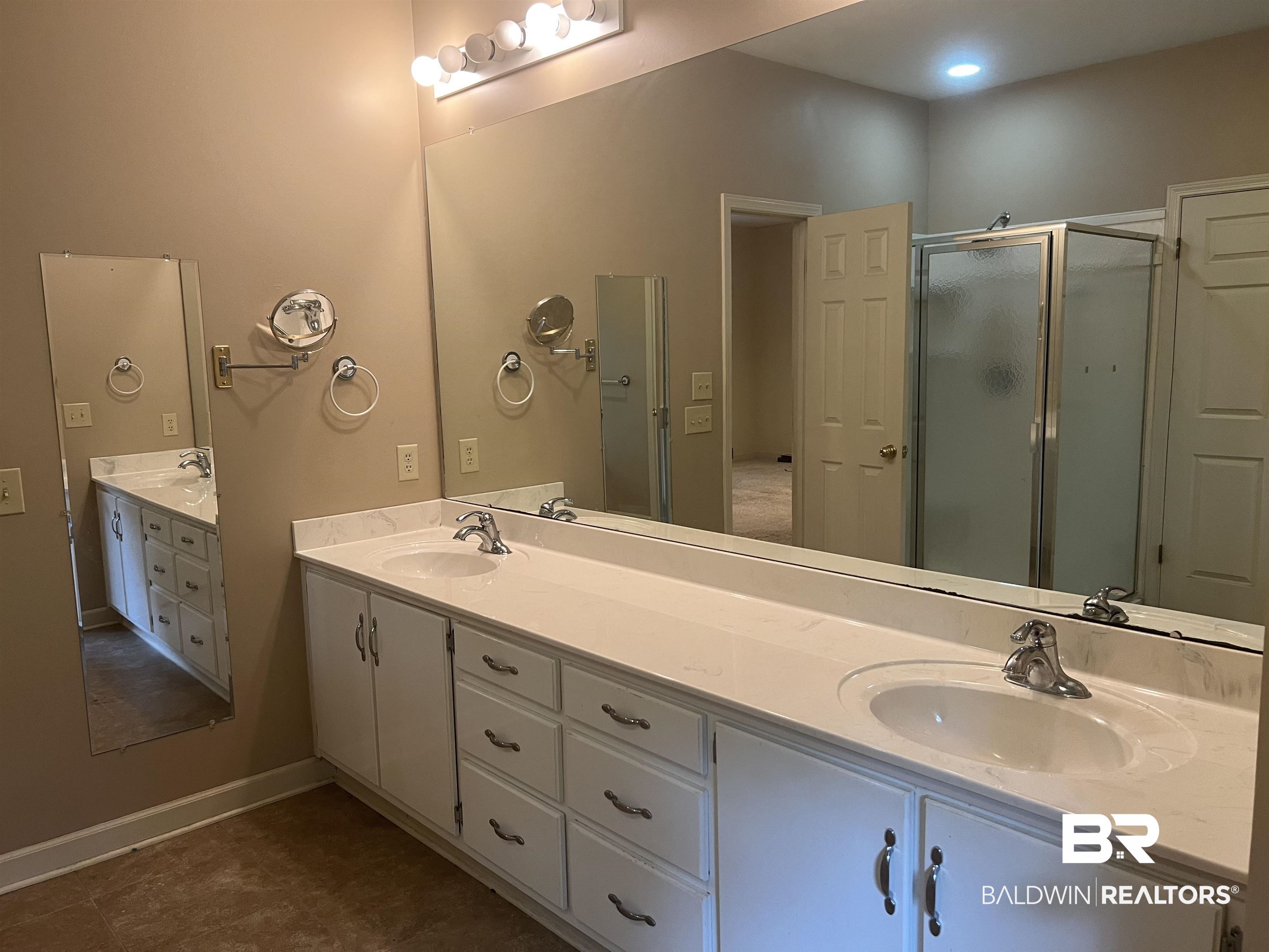 295 Norwood Road Monroeville, AL 36460 - Photo 11 of 32 Full bath with a stall shower, double vanity, and baseboards