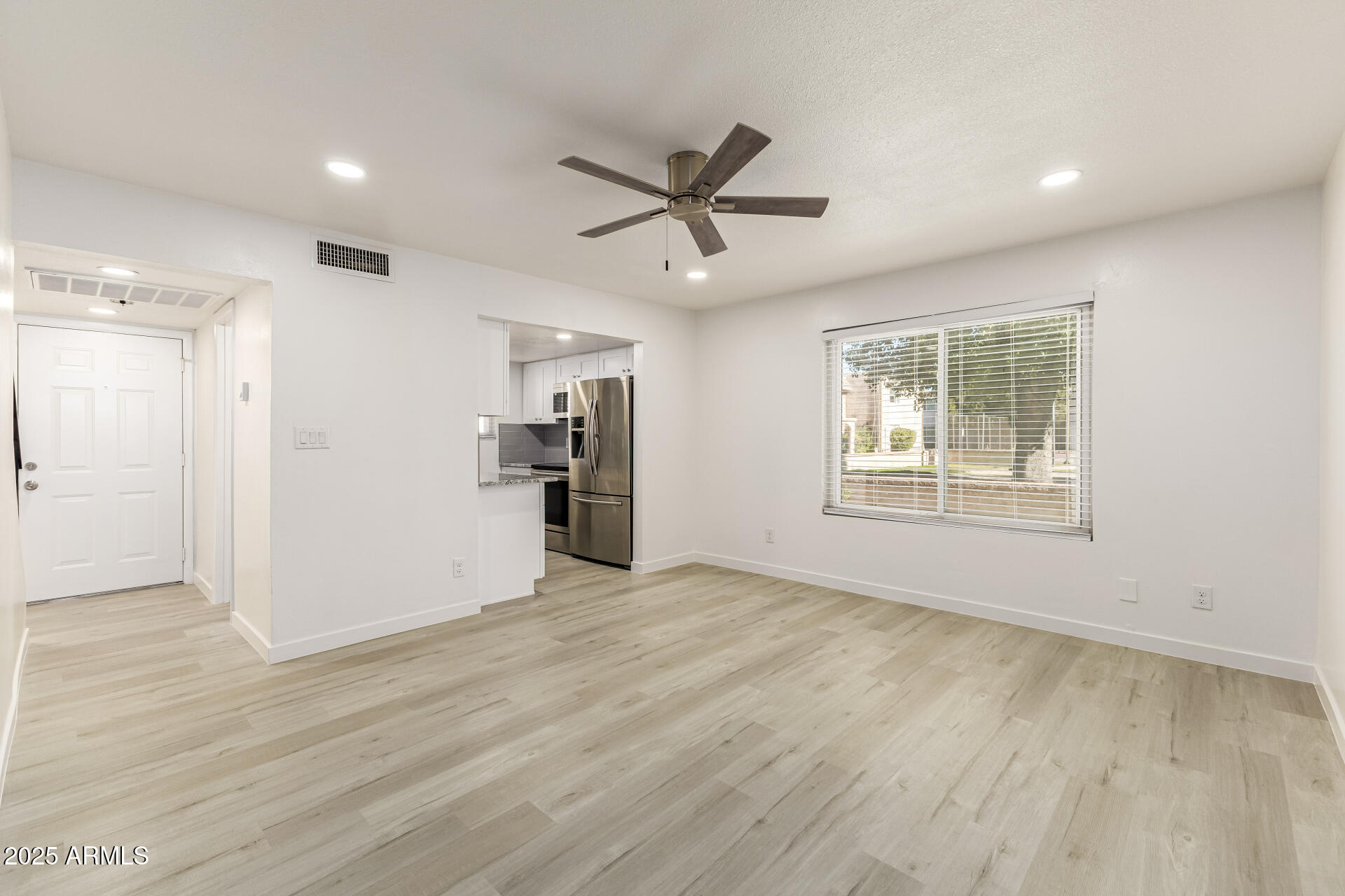 7126 North 19th Avenue, Unit 224 Phoenix, AZ 85021 - Photo 11 of 37 a view of an empty room with window and wooden floor