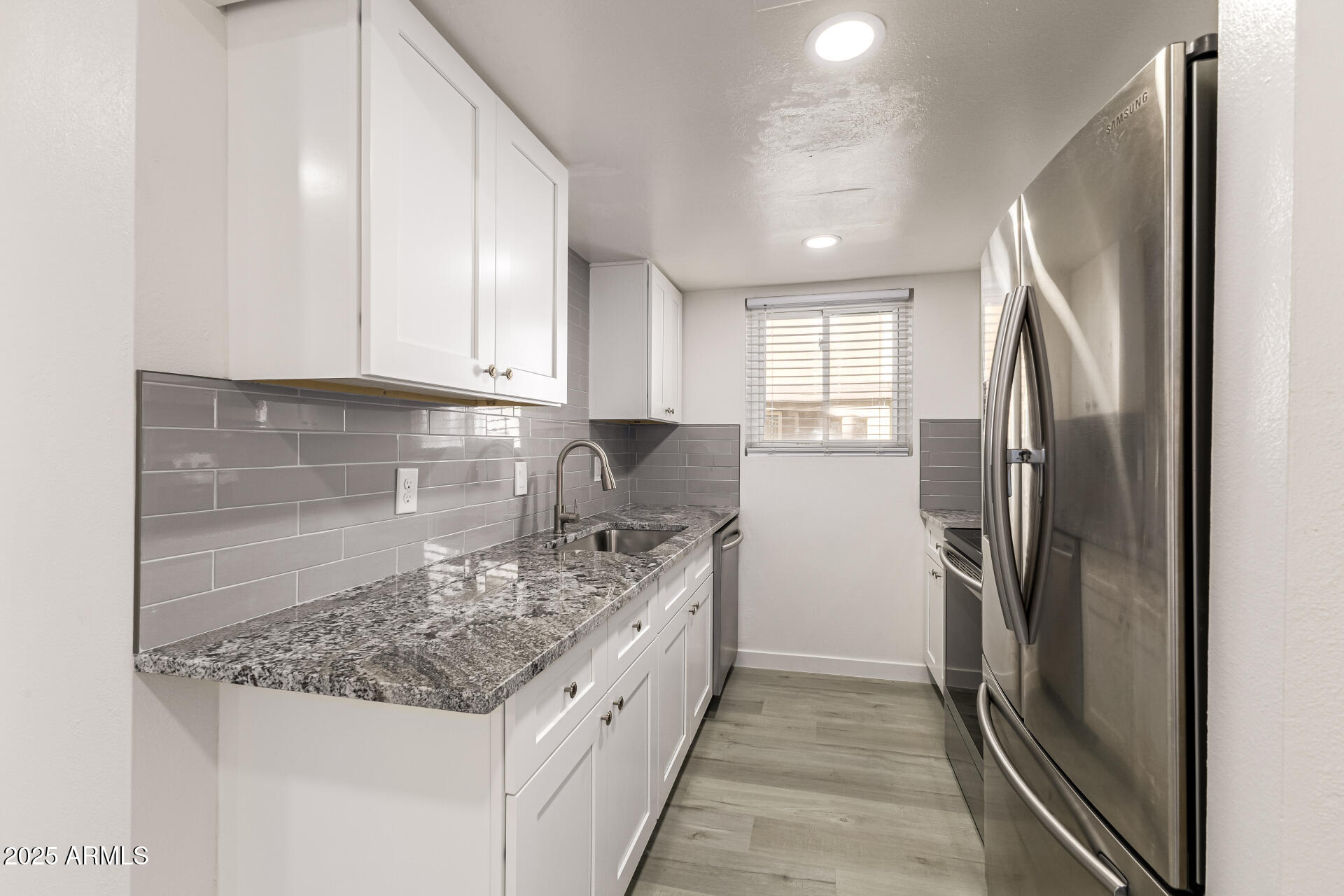 7126 North 19th Avenue, Unit 224 Phoenix, AZ 85021 - Photo 14 of 37 a kitchen with a refrigerator sink and cabinets