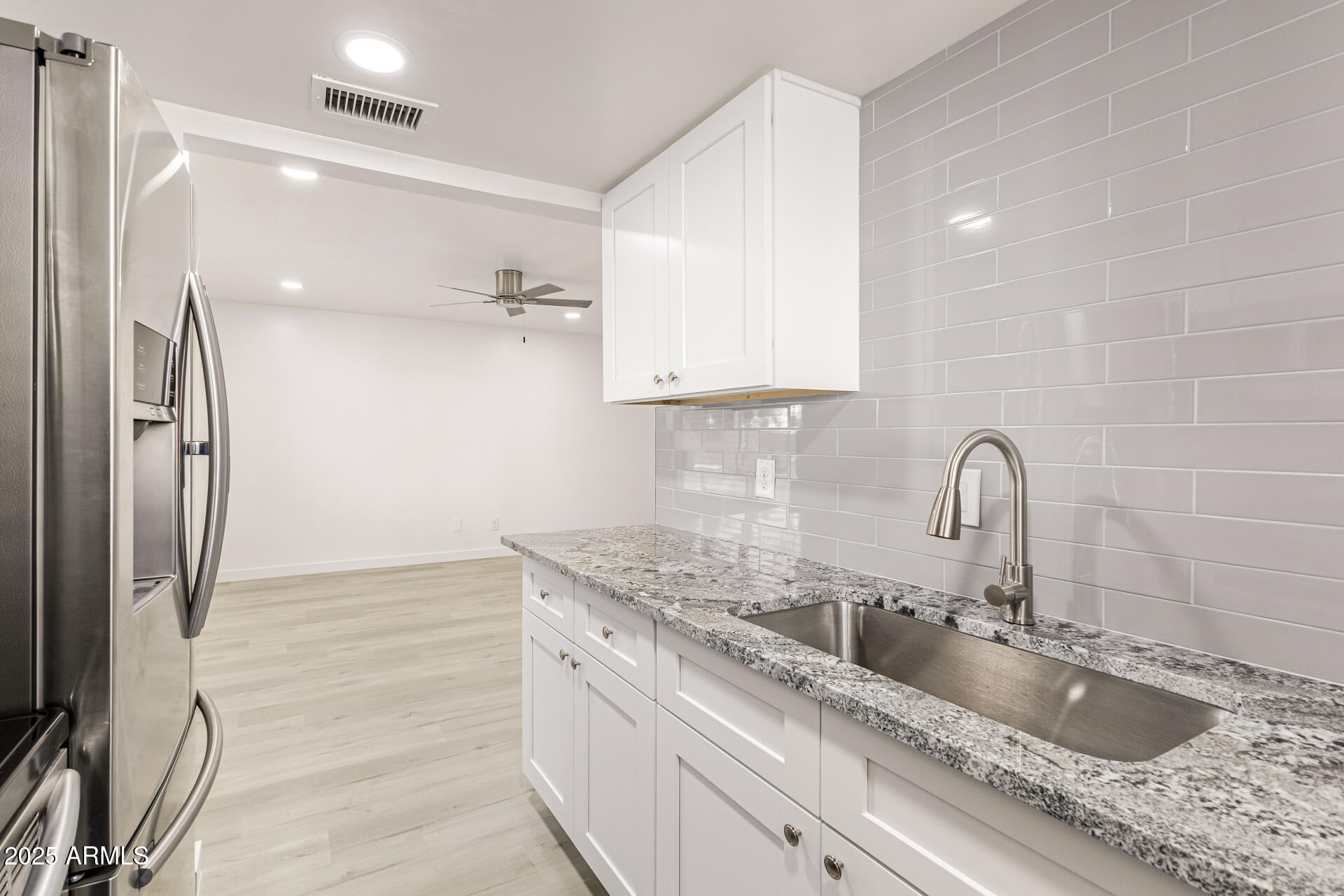 7126 North 19th Avenue, Unit 224 Phoenix, AZ 85021 - Photo 15 of 37 a close view of a sink a faucet and a refrigerator in a room