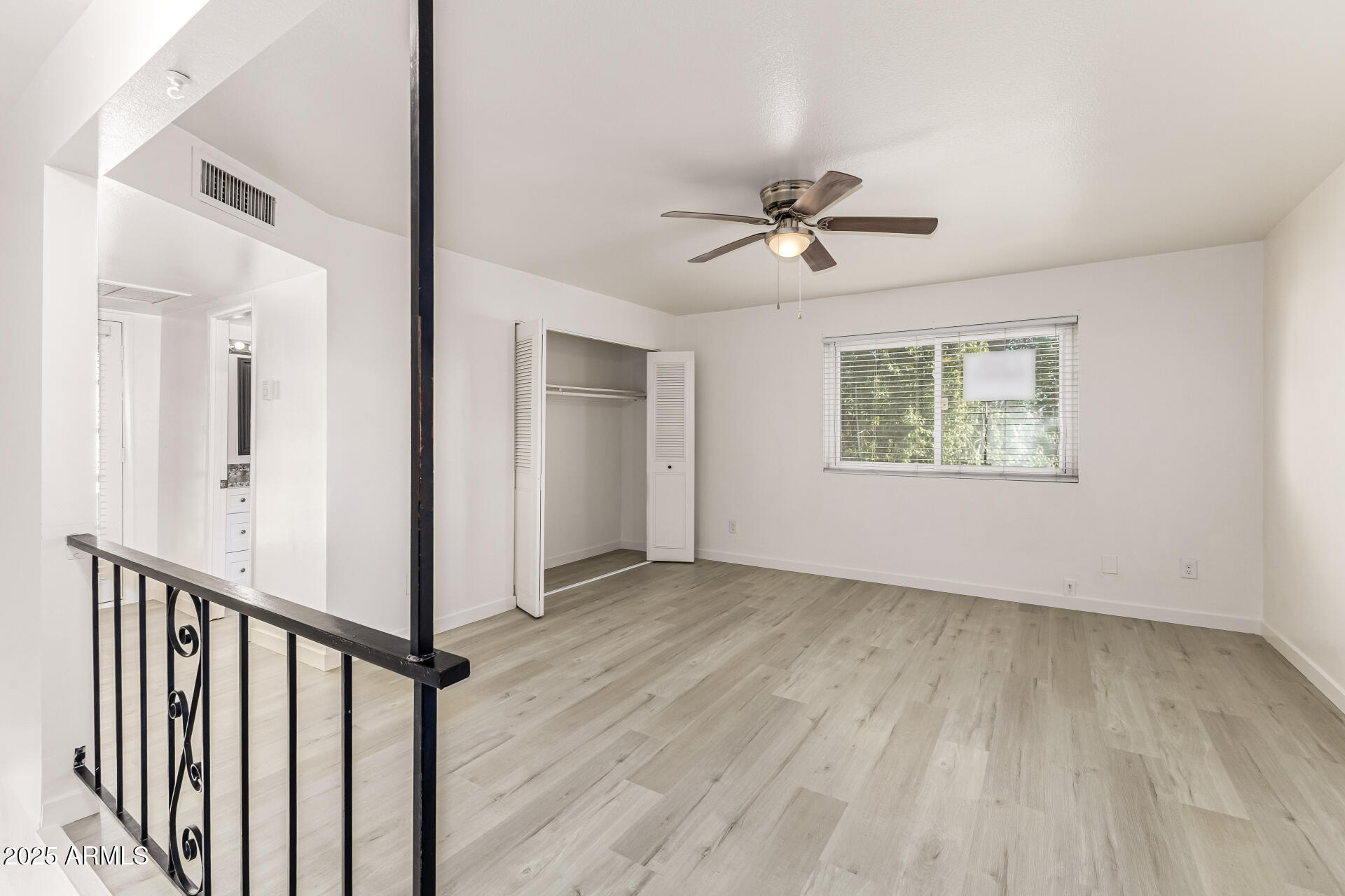 7126 North 19th Avenue, Unit 224 Phoenix, AZ 85021 - Photo 18 of 37 wooden floor in an empty room with a window
