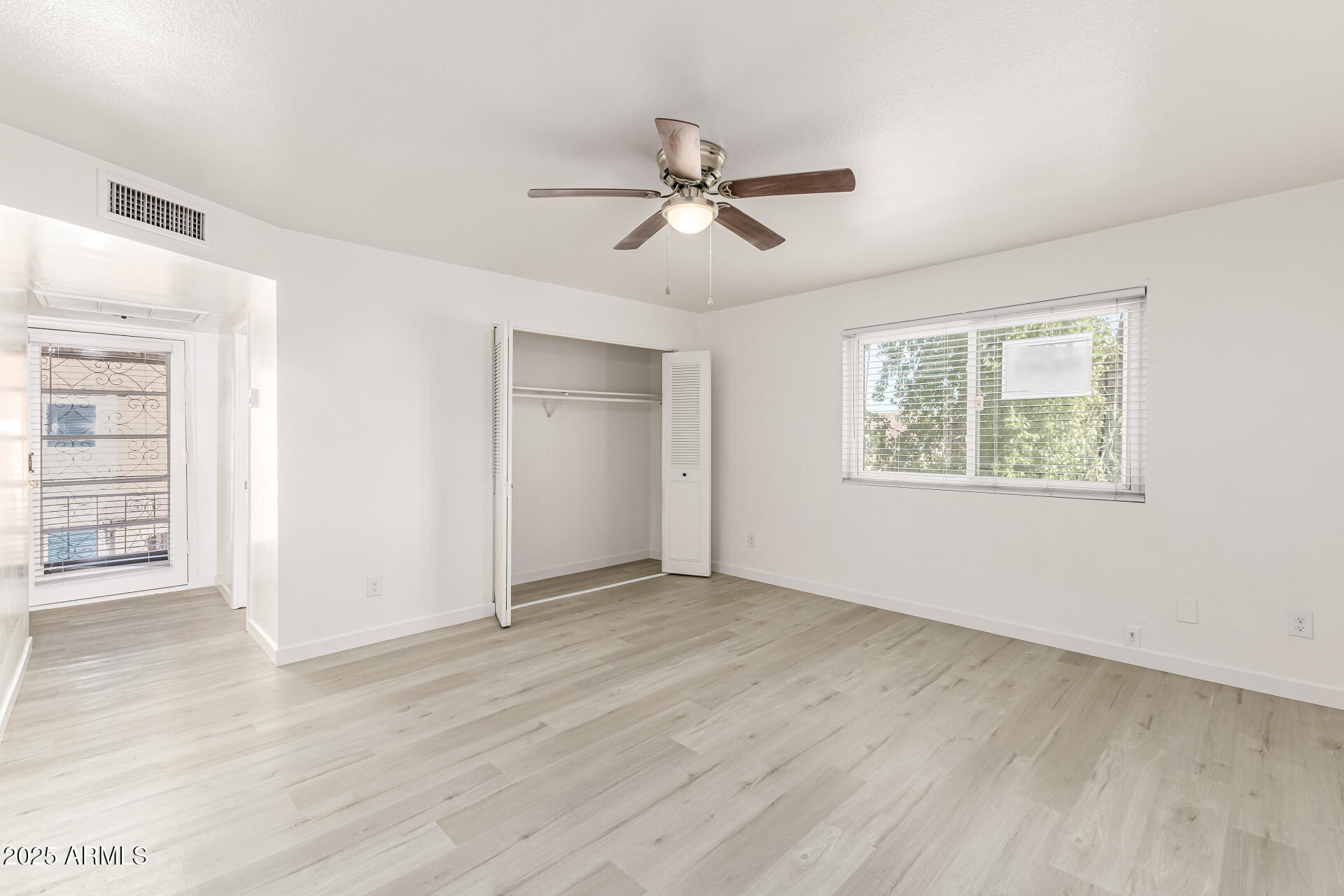 7126 North 19th Avenue, Unit 224 Phoenix, AZ 85021 - Photo 19 of 37 wooden floor in an empty room with a window