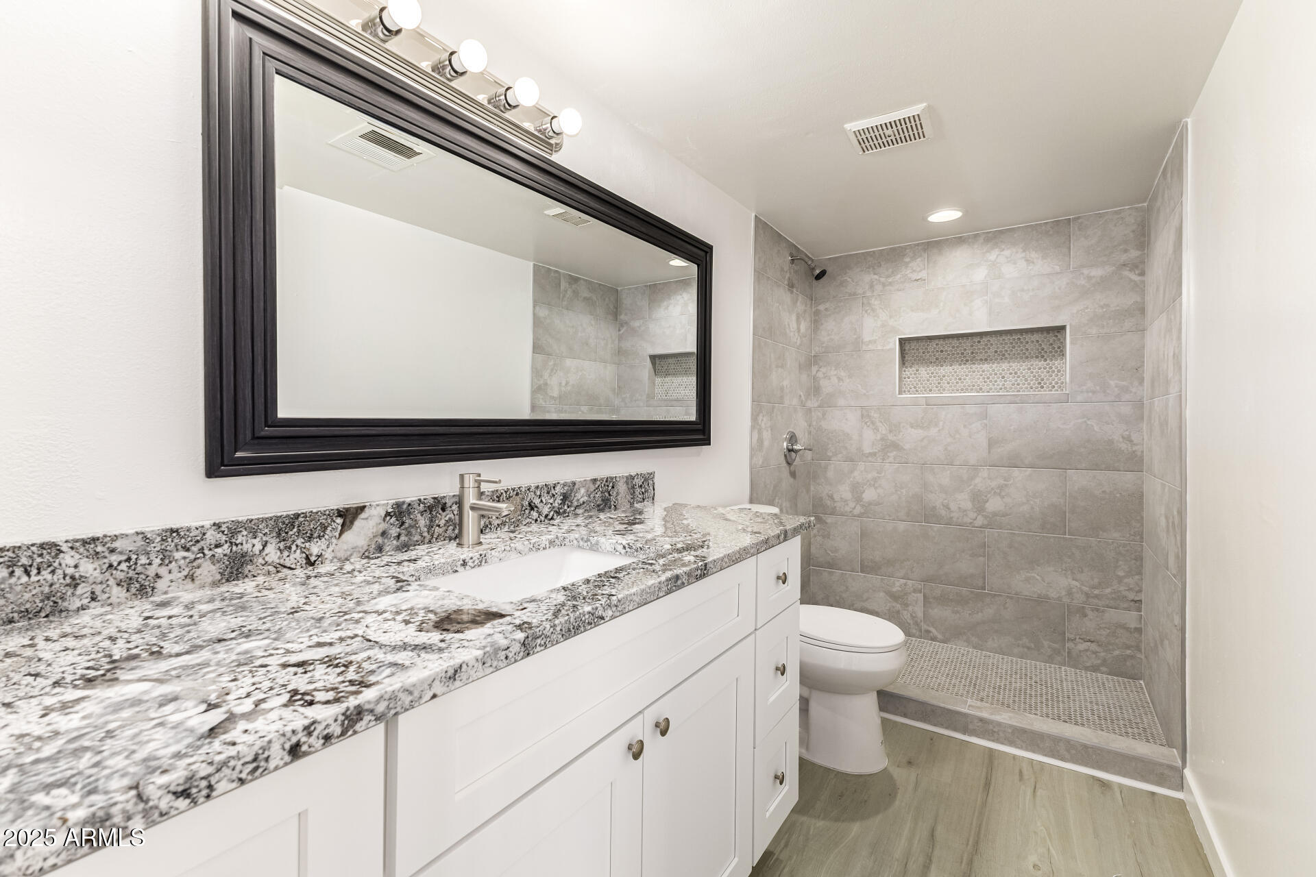 7126 North 19th Avenue, Unit 224 Phoenix, AZ 85021 - Photo 23 of 37 a bathroom with a granite countertop sink a toilet and a mirror
