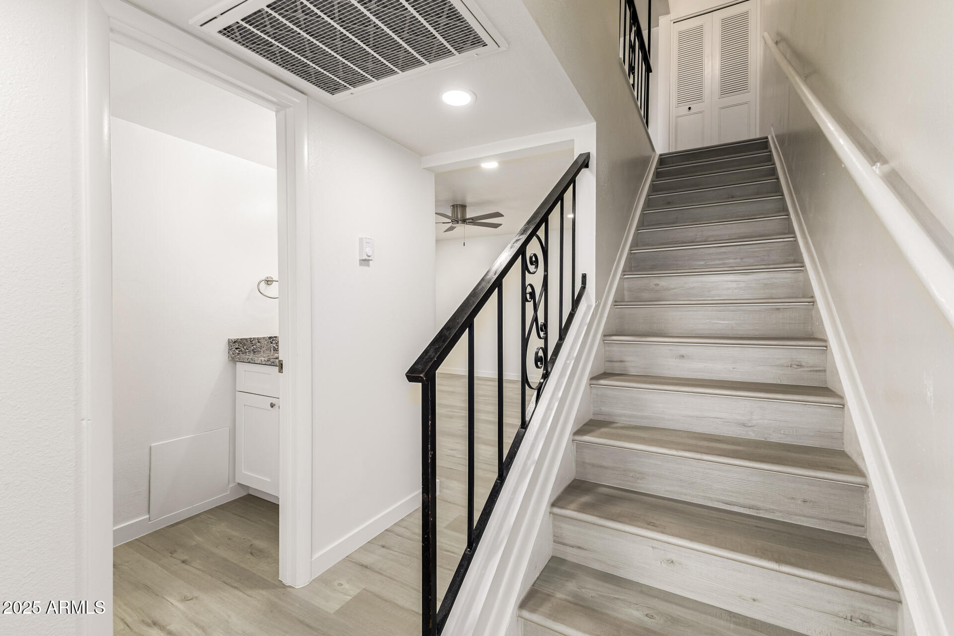 7126 North 19th Avenue, Unit 224 Phoenix, AZ 85021 - Photo 6 of 37 a view of staircase with wooden floor and fan