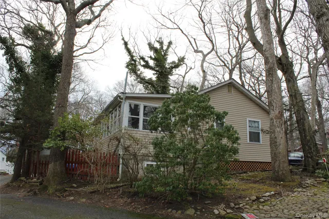 a view of a house with a tree in the forest