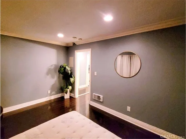a view of a room with wooden floor and potted plant