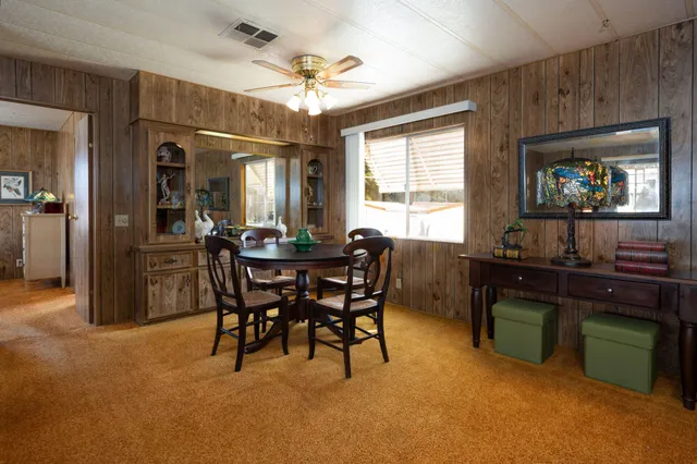 a view of a dining room with furniture and chandelier