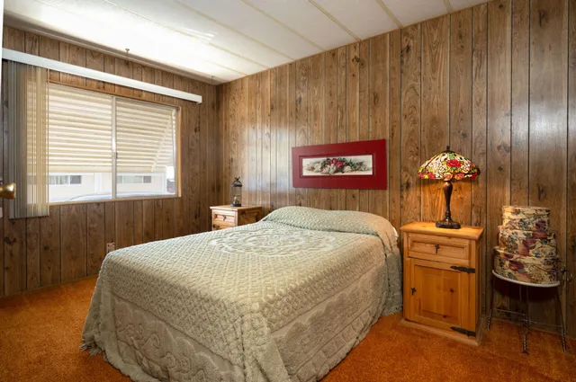 a bedroom with a bed and a table