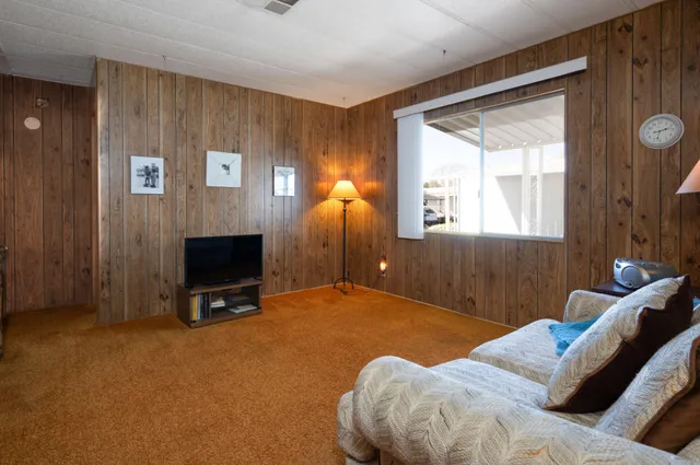 a bedroom with a bed and a tv