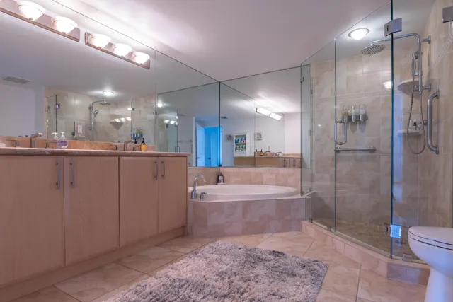 a bathroom with a bathtub a toilet a sink and shower