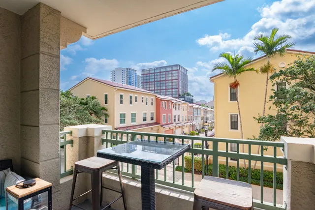 a view of a balcony with furniture and a potted plant