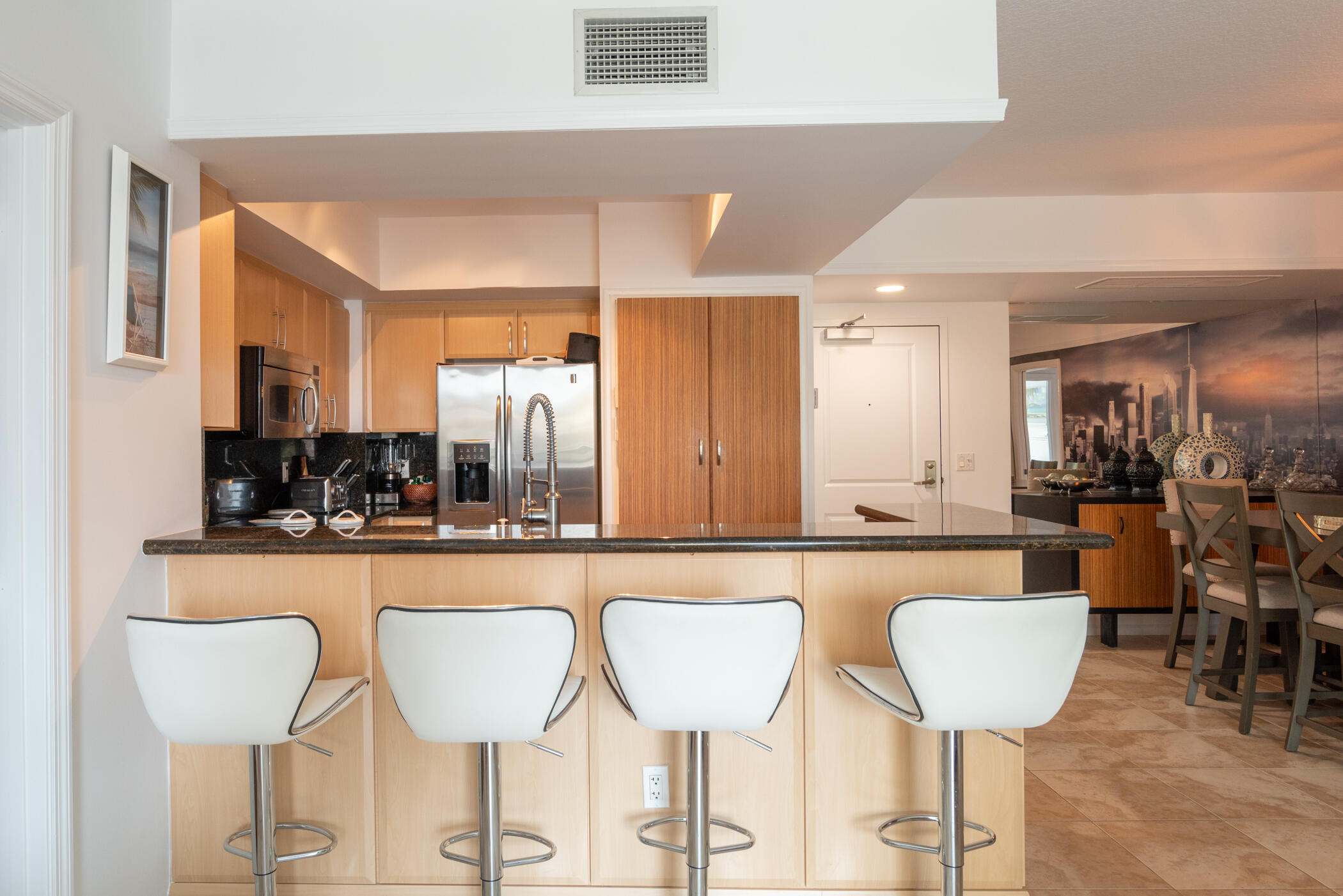 403 South Sapodilla Avenue, Unit 207 West Palm Beach, FL 33401 - Photo 16 of 32 a large kitchen with a dining table and chairs