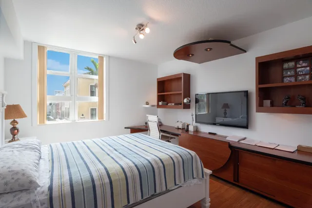 a bedroom with a bed and a flat screen tv