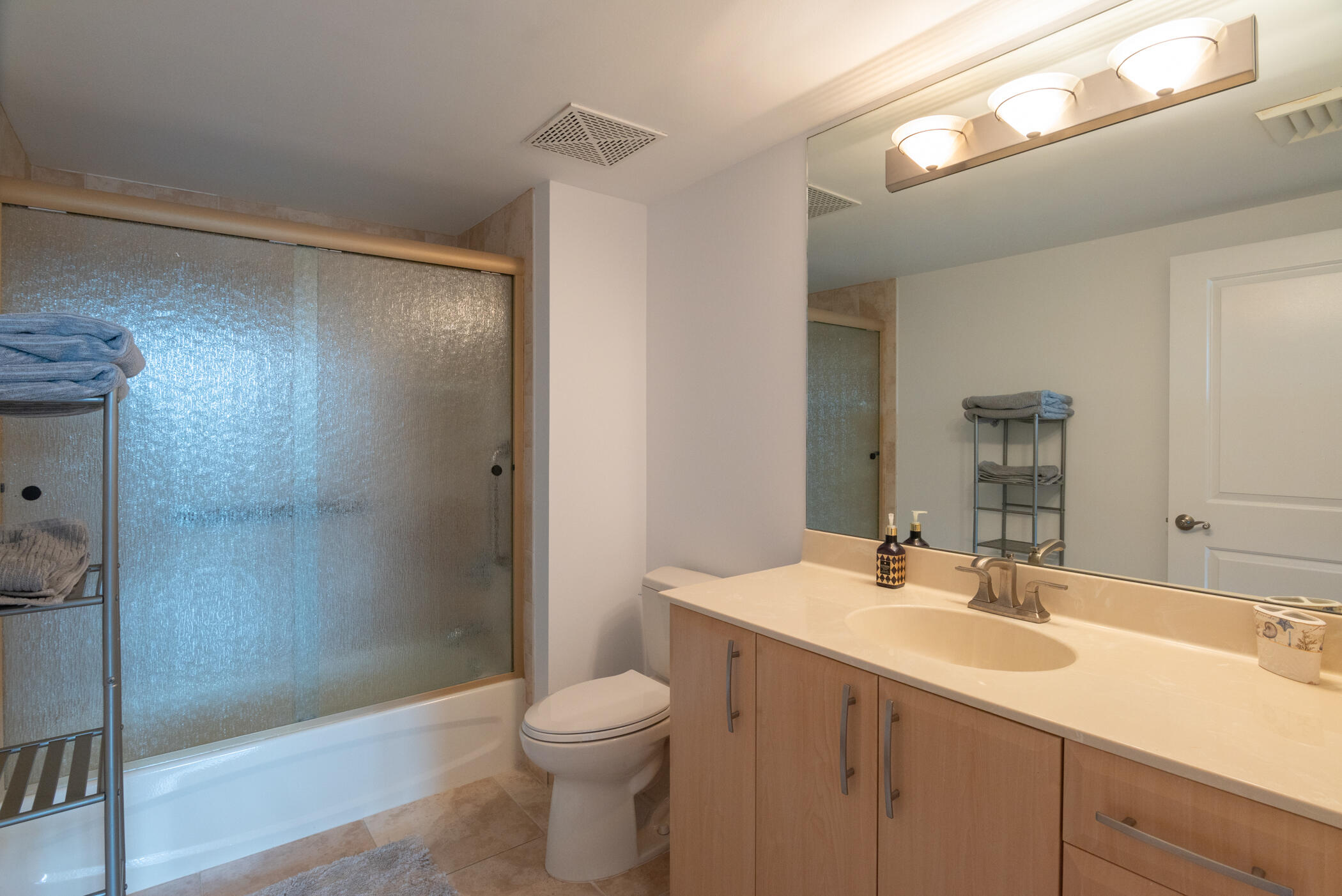 403 South Sapodilla Avenue, Unit 207 West Palm Beach, FL 33401 - Photo 19 of 32 a bathroom with a sink a toilet and shower
