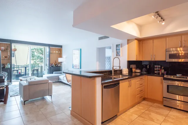 a kitchen with stainless steel appliances granite countertop a sink and cabinets