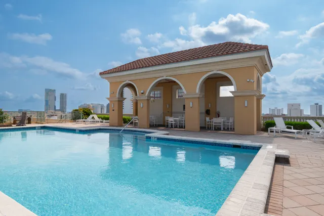 a front view of a house with swimming pool having outdoor seating
