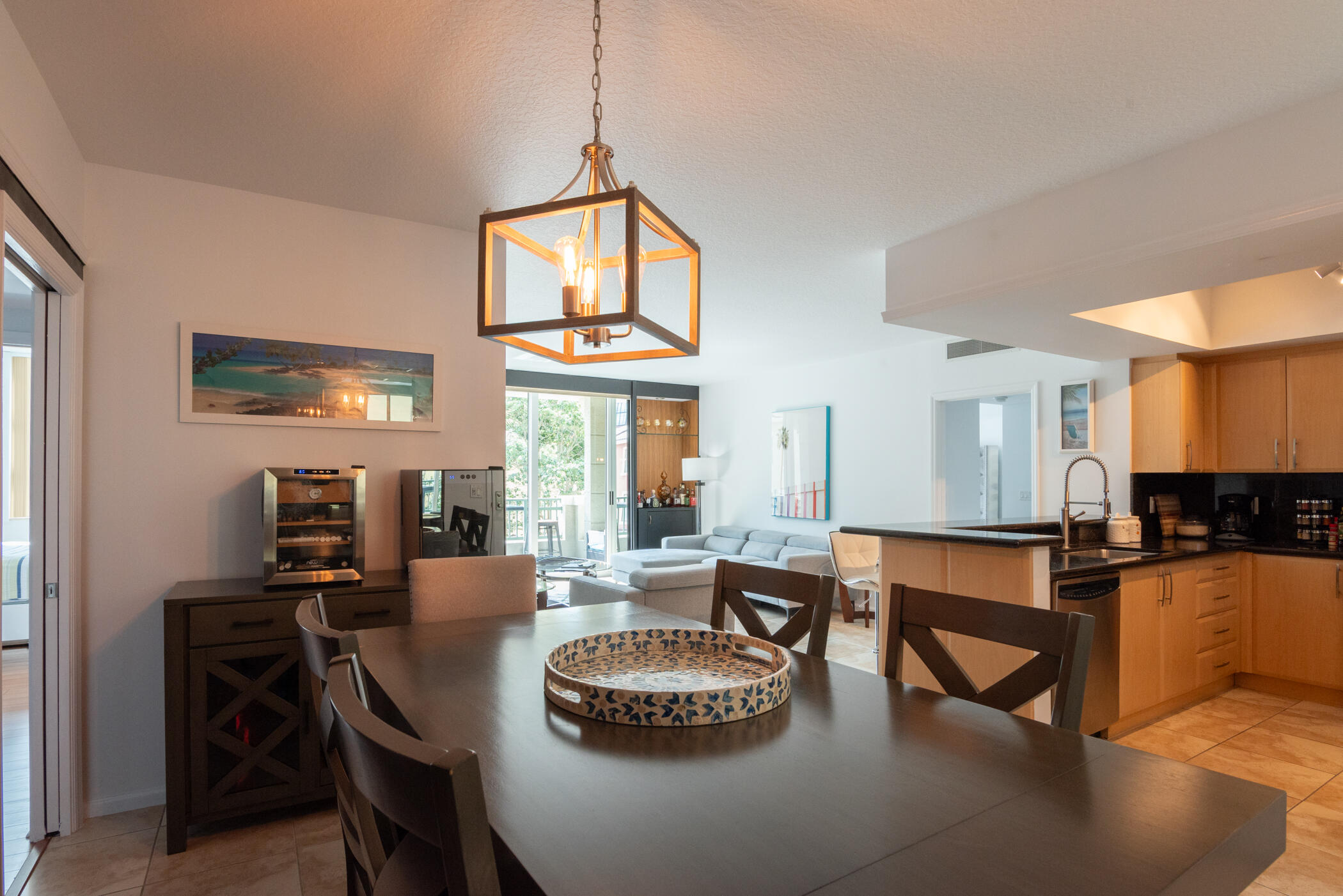 403 South Sapodilla Avenue, Unit 207 West Palm Beach, FL 33401 - Photo 5 of 32 a kitchen with a dining table and chairs