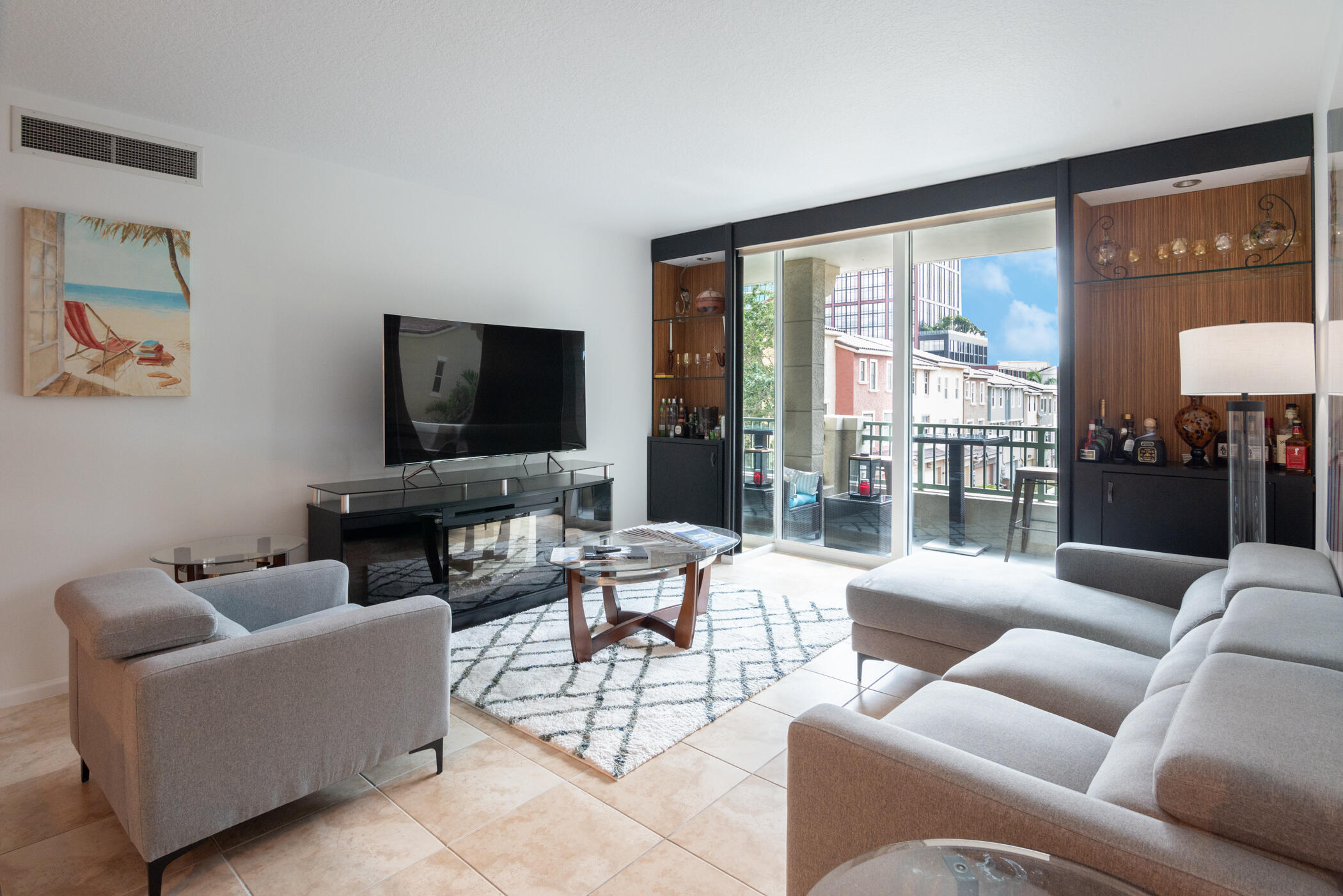403 South Sapodilla Avenue, Unit 207 West Palm Beach, FL 33401 - Photo 8 of 32 a living room with furniture and a flat screen tv