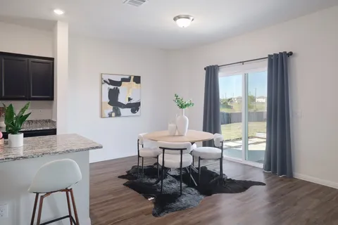 a view of a dining room with furniture window and wooden floor
