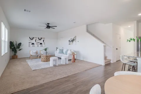 a kitchen with a table chairs refrigerator and microwave