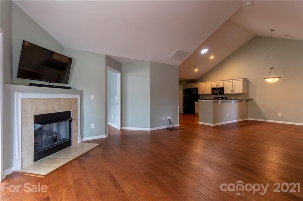 846 Ledgestone Court Tega Cay, SC 29708 - Photo 8 of 41 a view of empty room with wooden floor and a fireplace