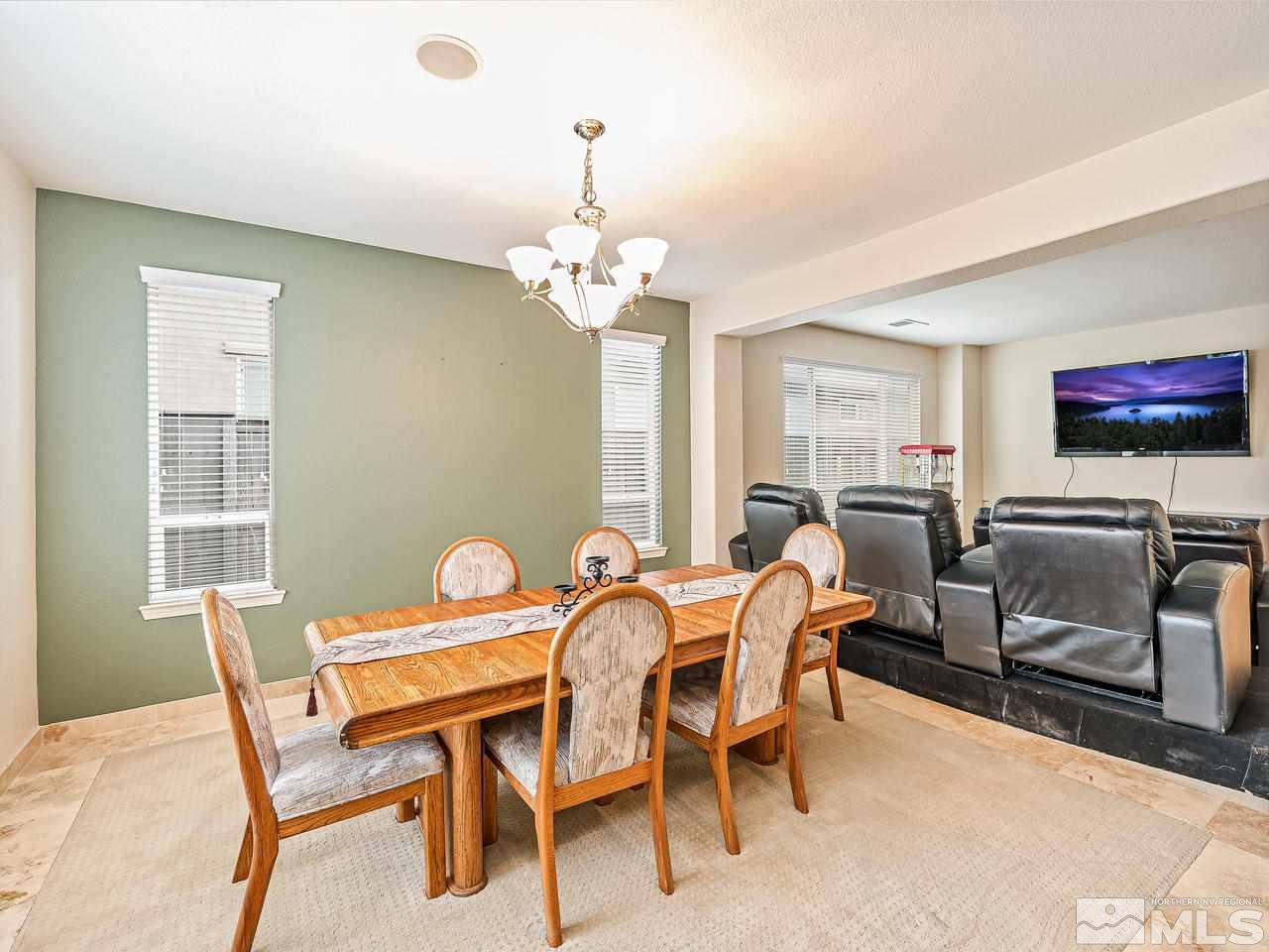 521 Secretariat Court Reno, NV 89521 - Photo 8 of 25 a view of a dining room with furniture a chandelier and a window