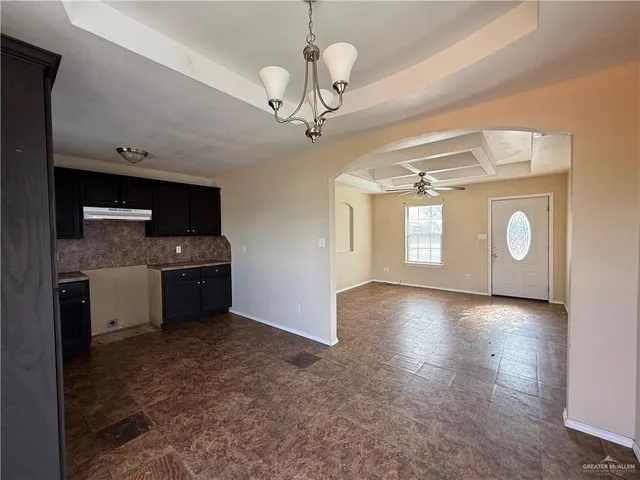 a view of a kitchen with a sink and dishwasher a refrigerator with wooden floor